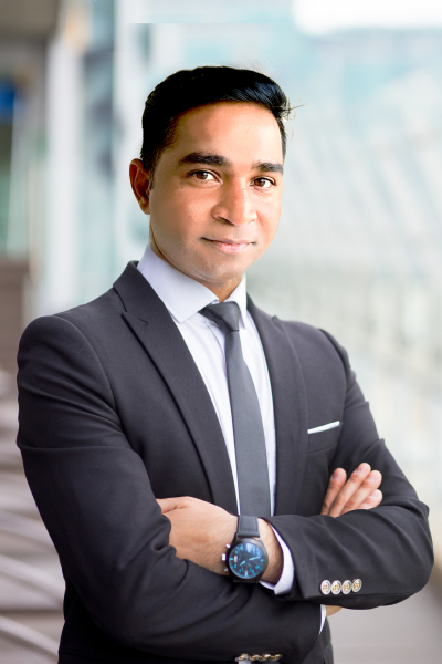Closeup of Confident Middle-aged Business Leader Closeup portrait of serious middle-aged handsome business man looking at camera and standing with his arms crossed